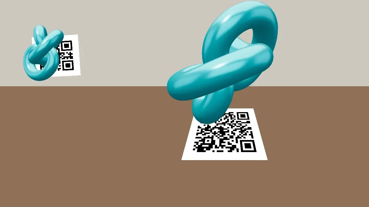 Objeto con ancla: la cámara detecta un código QR impreso y aparece encima un objeto en 3D que lo sigue