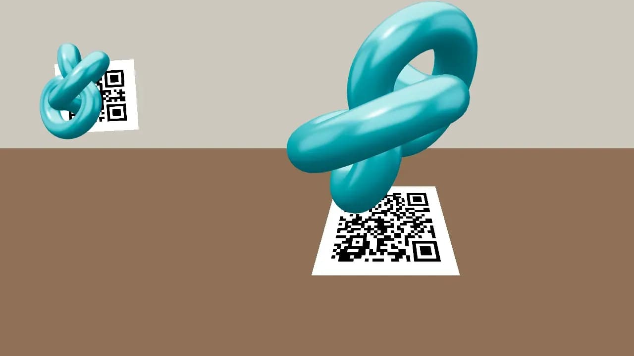 Objeto con ancla: dos códigos QR impresos, uno sobre una mesa y otro en la pared, cada uno con un objeto 3D celeste encima que lo sigue
